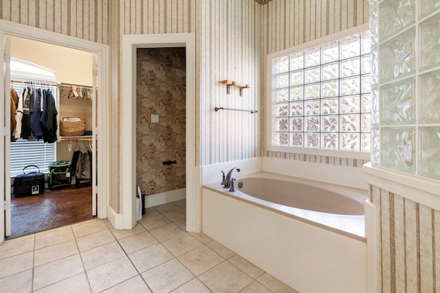 bathroom featuring tile patterned floors and a washtub