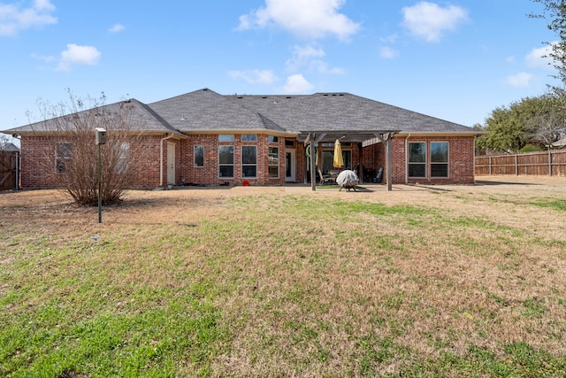 rear view of property featuring a yard and a patio area