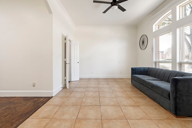 living room with light tile patterned flooring, ornamental molding, and ceiling fan