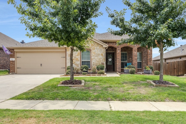 view of front of home with a garage and a front yard