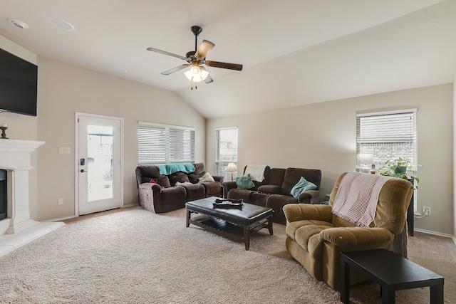 living room with vaulted ceiling, light colored carpet, and ceiling fan