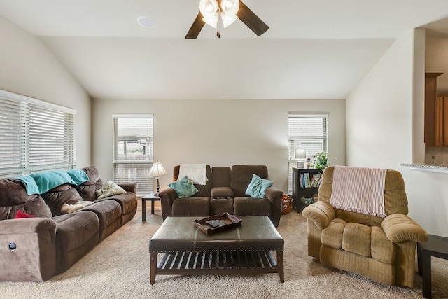 living room featuring lofted ceiling, light colored carpet, and ceiling fan