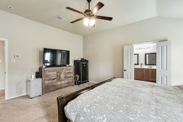 carpeted bedroom with lofted ceiling, sink, connected bathroom, and ceiling fan