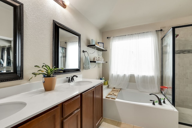 bathroom with vanity, vaulted ceiling, and shower with separate bathtub