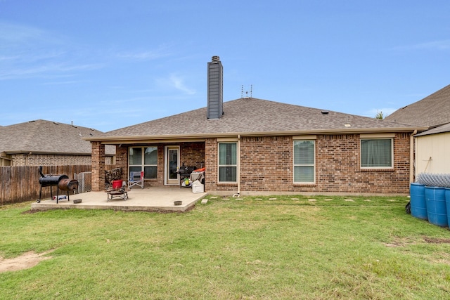 rear view of property with a patio area and a lawn