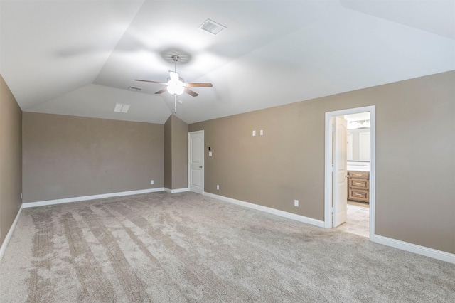 empty room with ceiling fan, light carpet, and lofted ceiling