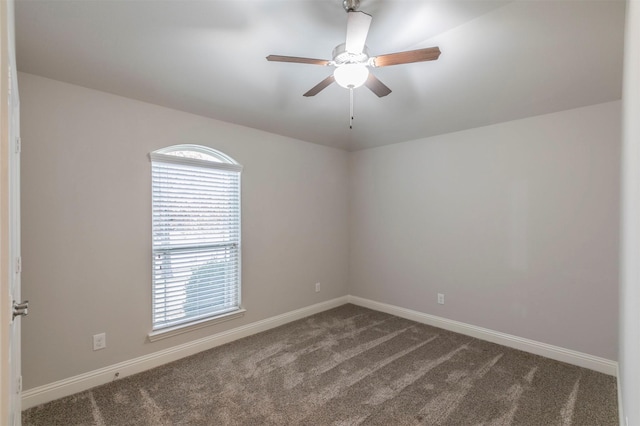 carpeted spare room with ceiling fan