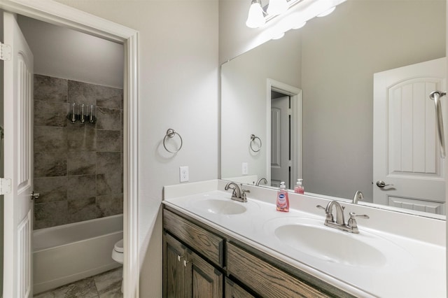 full bathroom featuring vanity, tiled shower / bath, toilet, and tile patterned floors