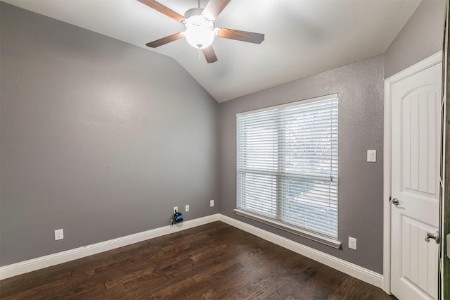 empty room with lofted ceiling, ceiling fan, and dark hardwood / wood-style floors