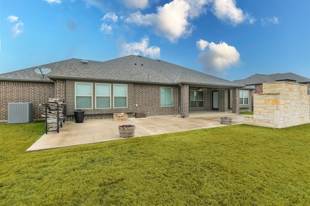 rear view of house featuring a patio, cooling unit, and a yard