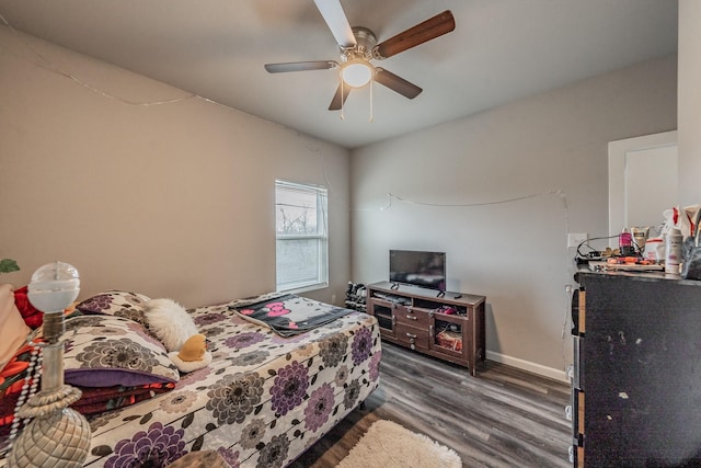 bedroom with dark wood-type flooring and ceiling fan