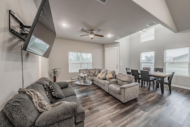 living room featuring dark hardwood / wood-style flooring, a wealth of natural light, and ceiling fan