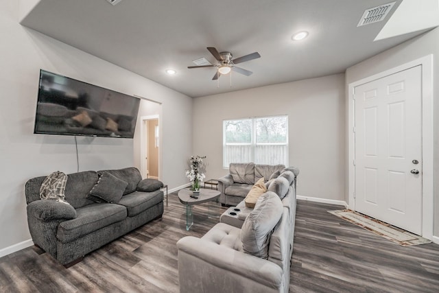 living room with ceiling fan and dark hardwood / wood-style floors