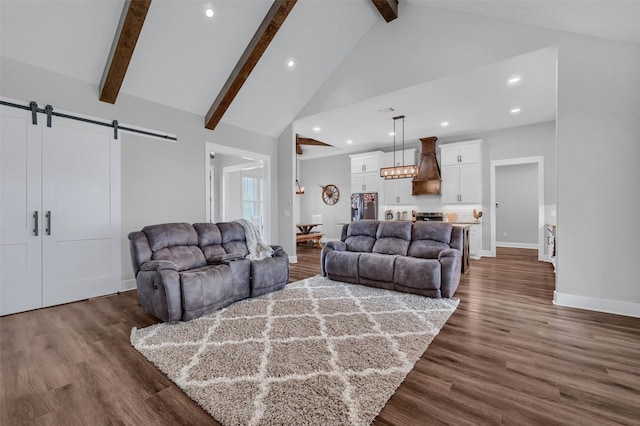 living room with a barn door, dark hardwood / wood-style floors, high vaulted ceiling, and beam ceiling