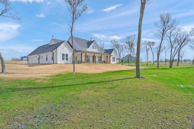 view of front of home with a garage, a front lawn, and covered porch