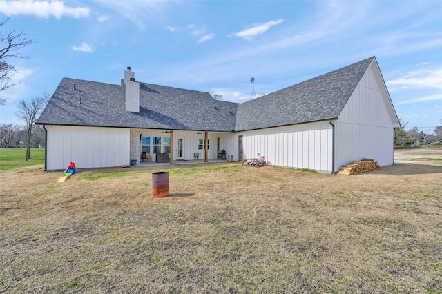 back of property with a patio and a yard