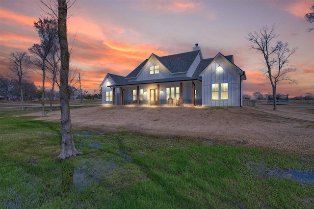 modern inspired farmhouse featuring a lawn