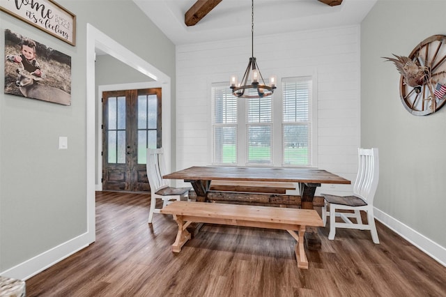 dining room featuring an inviting chandelier, dark wood-type flooring, and french doors