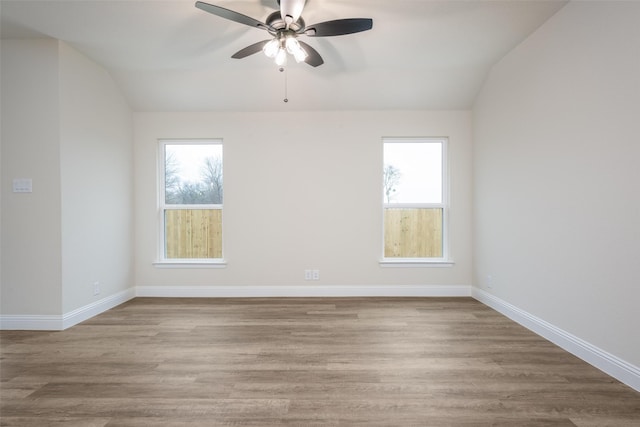 102 Walnut St, Whitesboro, TX 76273 - empty room featuring lofted ceiling, plenty of natural light, a ceiling fan, wood finished floors, and baseboards