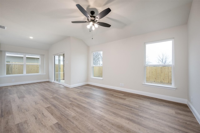 unfurnished room featuring lofted ceiling, visible vents, ceiling fan, and wood finished floors
