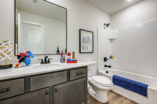 full bathroom featuring vanity, wood-type flooring, toilet, and washtub / shower combination