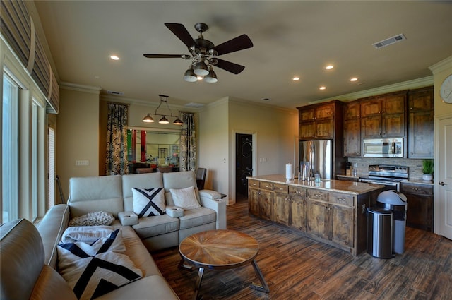 living room with ornamental molding, dark hardwood / wood-style floors, and ceiling fan