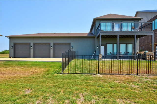 view of front of house with a garage, a balcony, and a front yard