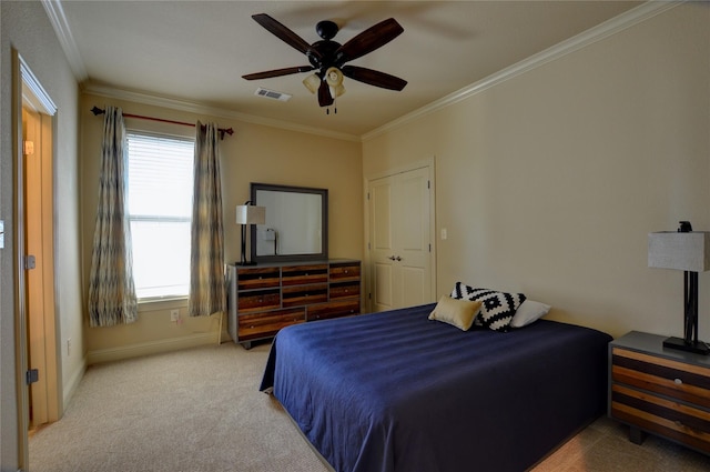 bedroom with ornamental molding, light colored carpet, and ceiling fan