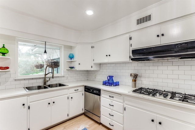 kitchen with open shelves, light countertops, a sink, dishwasher, and under cabinet range hood