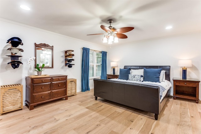 bedroom with ornamental molding, ceiling fan, and light wood finished floors