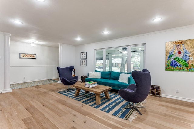 living room with decorative columns, baseboards, light wood-style flooring, and recessed lighting