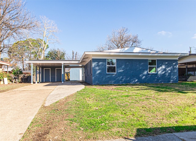 ranch-style house featuring a carport and a front yard