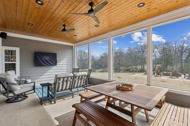 sunroom with ceiling fan and wooden ceiling