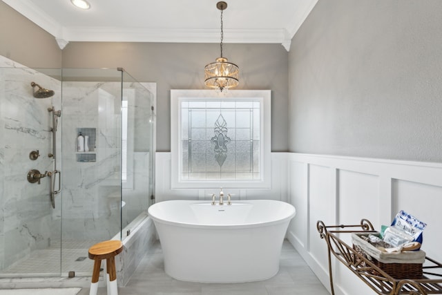 bathroom with an inviting chandelier, ornamental molding, and separate shower and tub