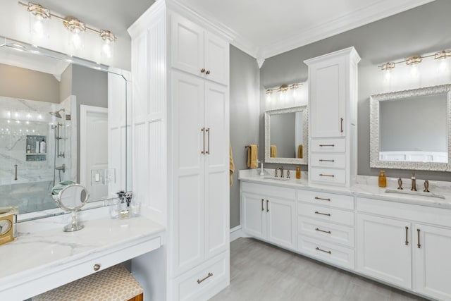 bathroom with crown molding, vanity, and walk in shower