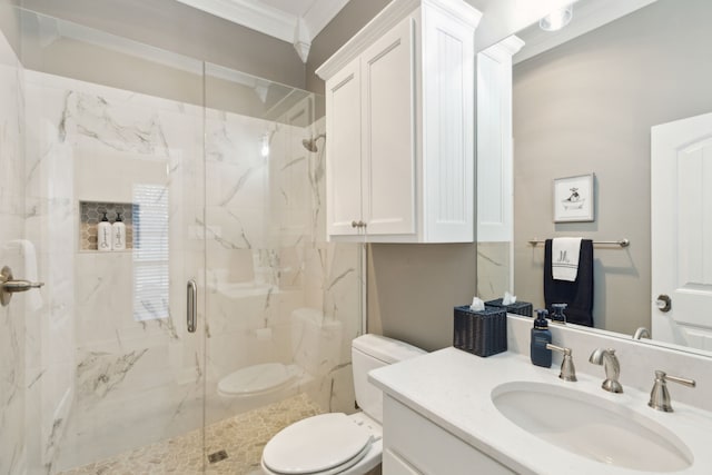 bathroom with a shower with door, crown molding, vanity, and toilet