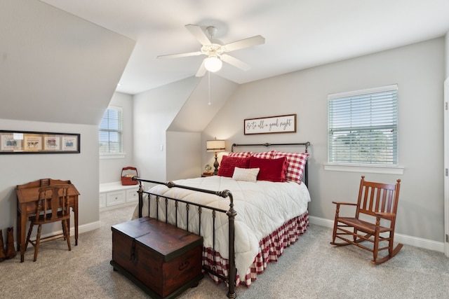 bedroom featuring vaulted ceiling, light colored carpet, and ceiling fan