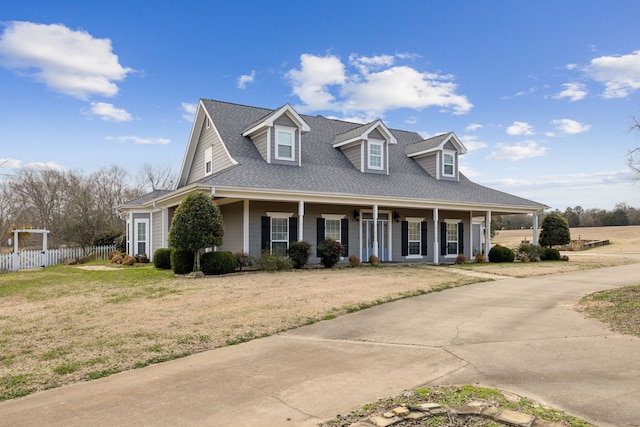 view of front of home with a front yard and covered porch