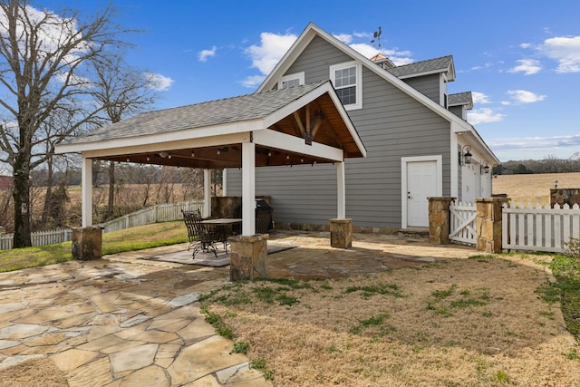 rear view of property featuring a gazebo and a patio area