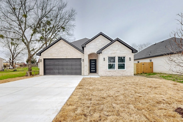 view of front of property featuring a garage and a front lawn