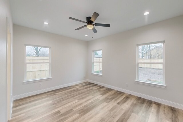 spare room with light hardwood / wood-style flooring and ceiling fan