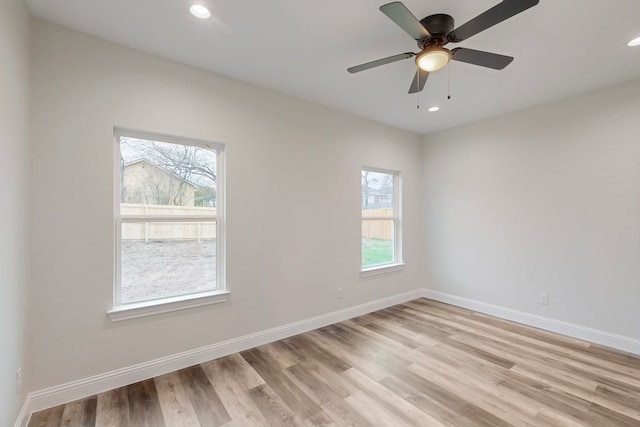 spare room featuring ceiling fan and light hardwood / wood-style flooring