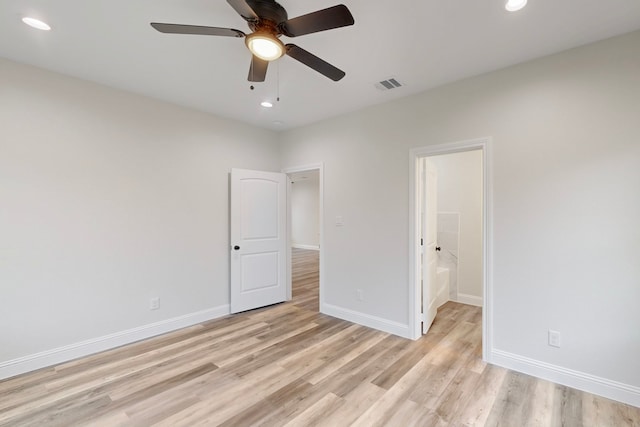 unfurnished bedroom with ceiling fan, connected bathroom, and light hardwood / wood-style flooring