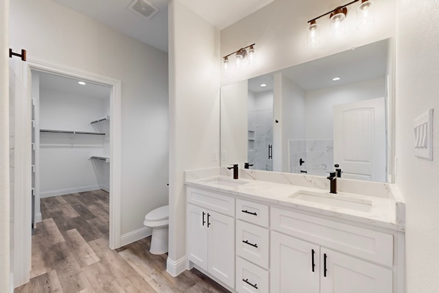 bathroom with vanity, hardwood / wood-style floors, and toilet