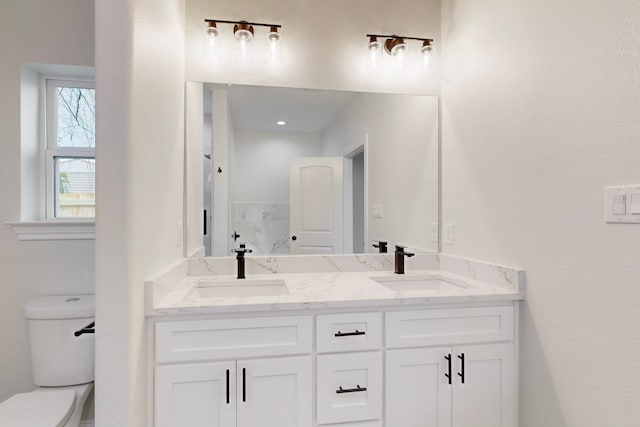 bathroom featuring vanity and toilet