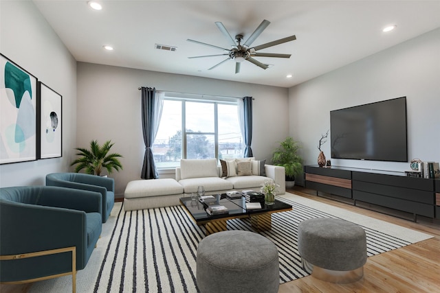 living room featuring ceiling fan and light wood-type flooring