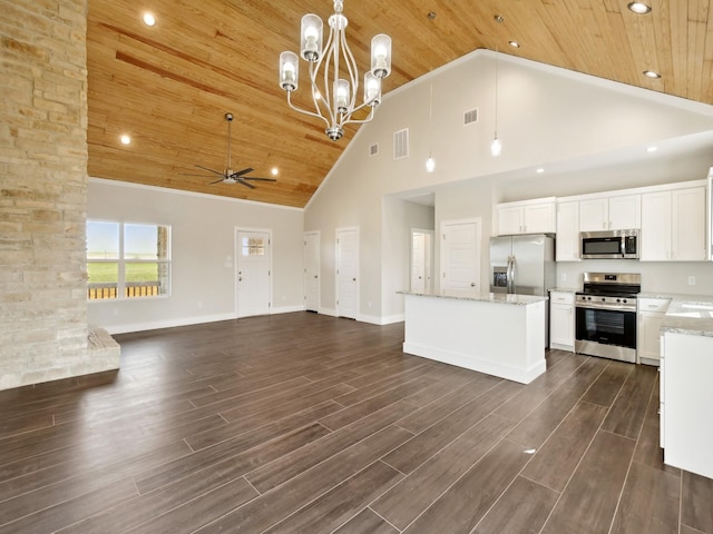 kitchen with a kitchen island, ceiling fan with notable chandelier, pendant lighting, white cabinetry, and stainless steel appliances