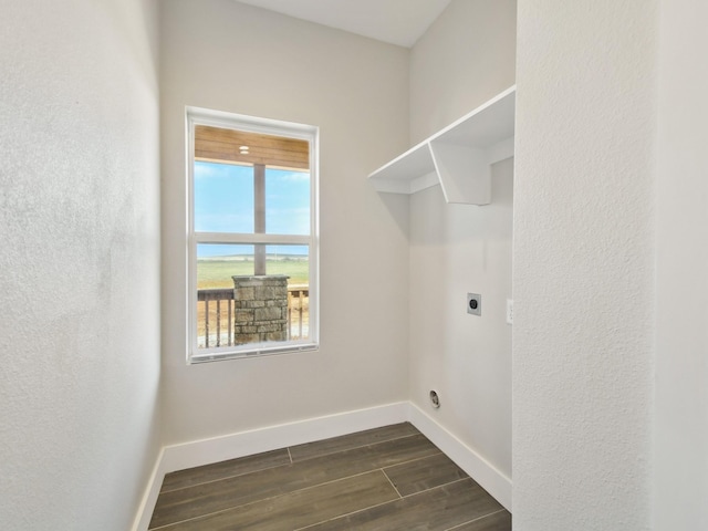 washroom featuring dark wood-type flooring and hookup for an electric dryer