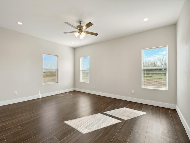 spare room with dark wood-type flooring and ceiling fan