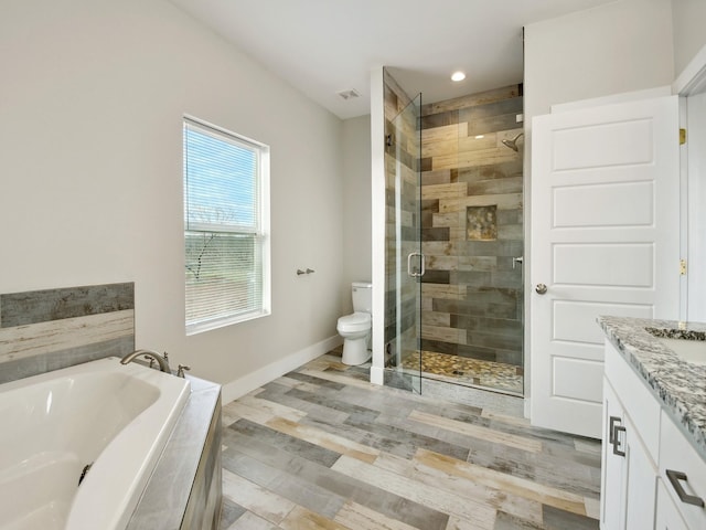 full bathroom featuring vanity, shower with separate bathtub, hardwood / wood-style floors, and toilet